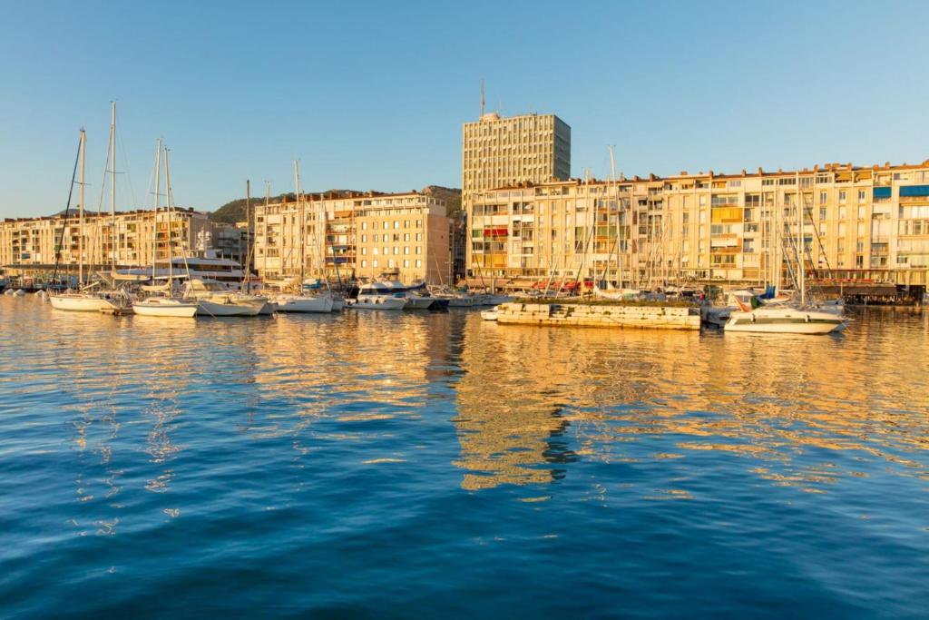 a group of boats docked in a harbor with buildings at Charming T2 Equipped 1min Walk To Beaches in Toulon