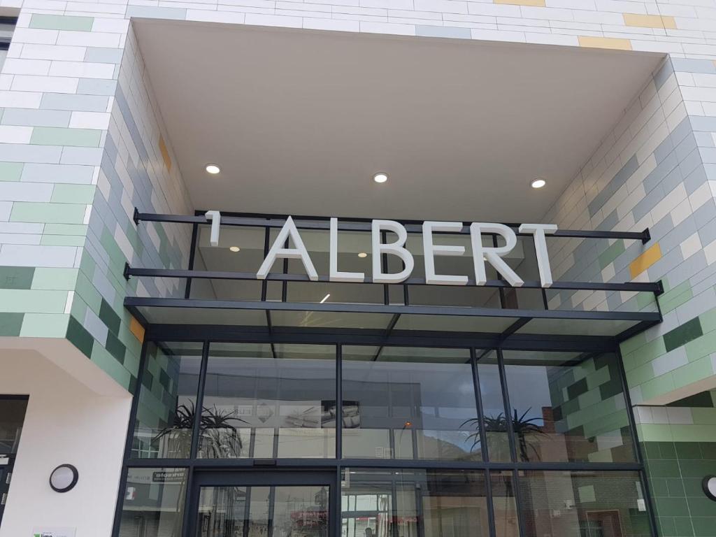 a retailer sign on the front of a building at 1 Albert Studio Apartment in Cape Town