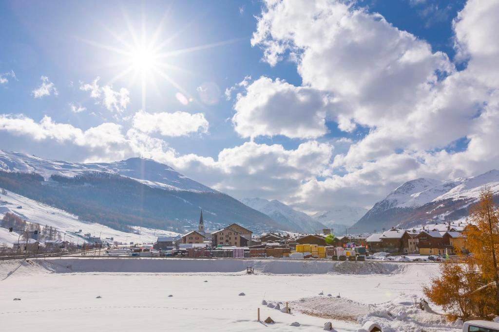 a town in the snow with mountains in the background at Danubio - Happy Rentals in Livigno