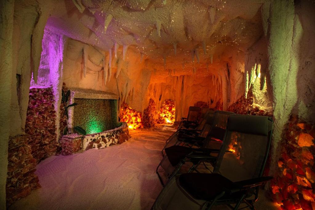 a room with a fireplace and chairs in a cave at Hotel Thermal in Karlovy Vary