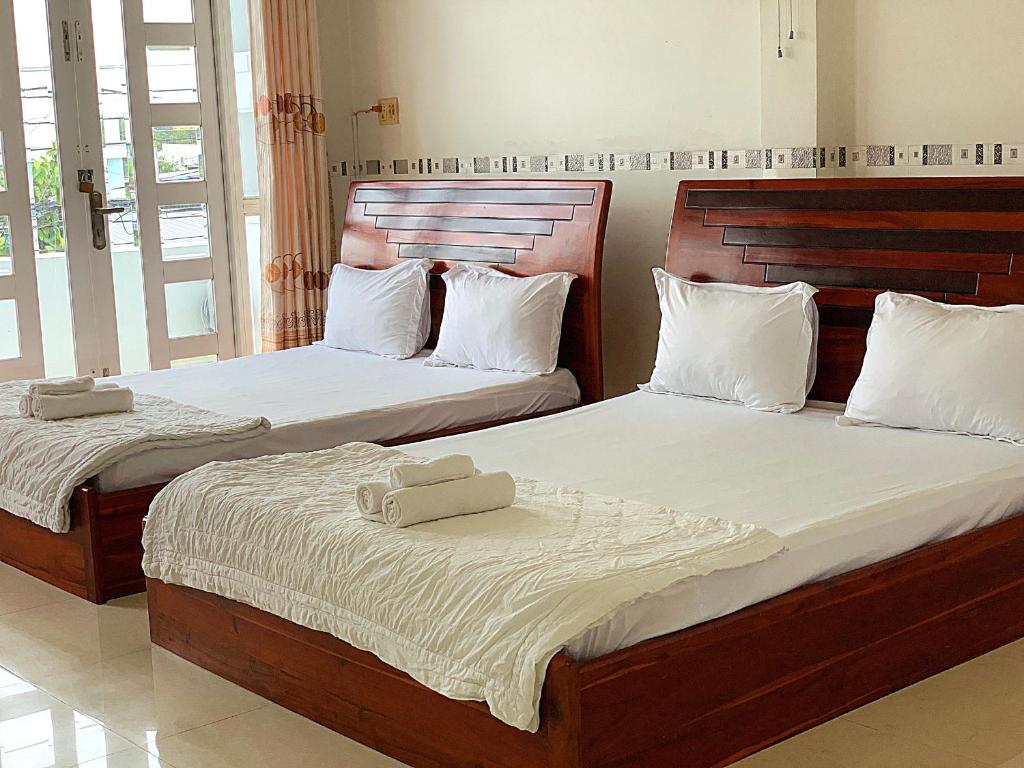Postel nebo postele na pokoji v ubytování Ngoc May Guesthouse