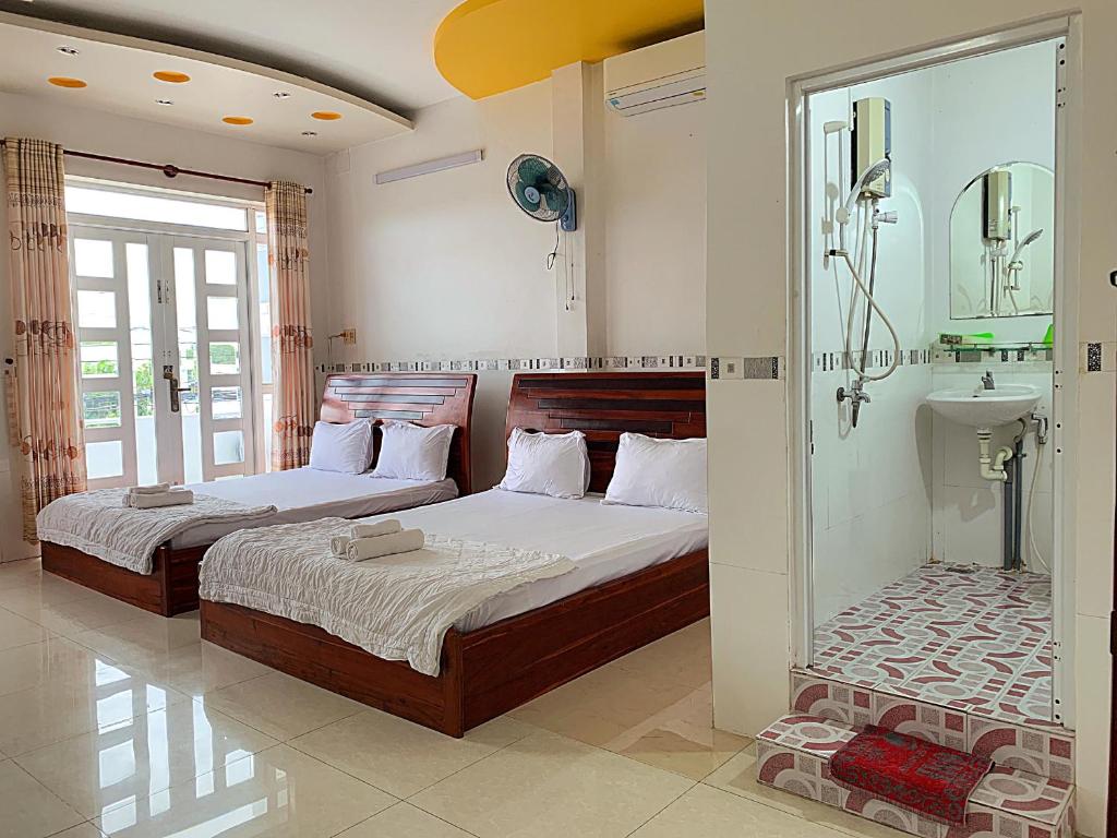 Postel nebo postele na pokoji v ubytování Ngoc May Guesthouse