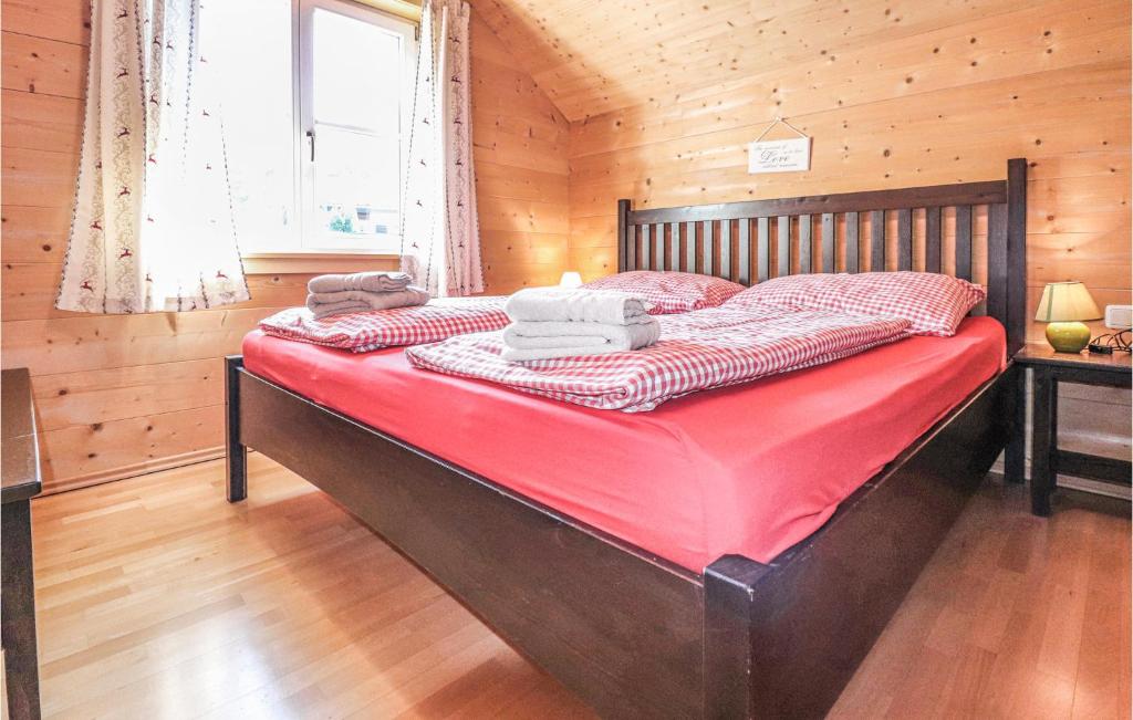 a bedroom with a large bed in a cabin at Lovely Home In Dalaas With Kitchen in Dalaas