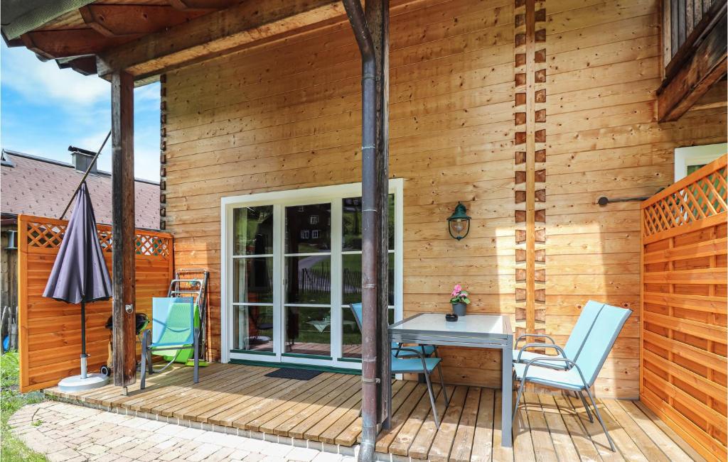 a wooden deck with a table and chairs on it at Lovely Home In Dalaas With Kitchen in Dalaas