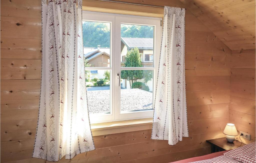 a bedroom with a window in a log cabin at Lovely Home In Dalaas With Kitchen in Dalaas