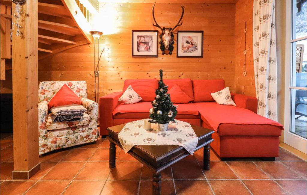 a living room with a red couch and a table at Lovely Home In Dalaas With Kitchen in Dalaas