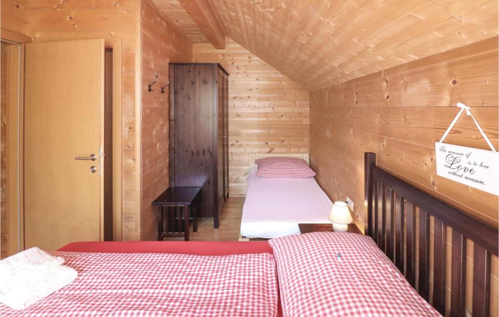 a room with two beds in a wooden cabin at Lovely Home In Dalaas With Kitchen in Dalaas