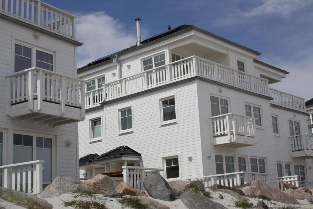 a large white house with a balcony on top at Ostseeperle in Kappeln