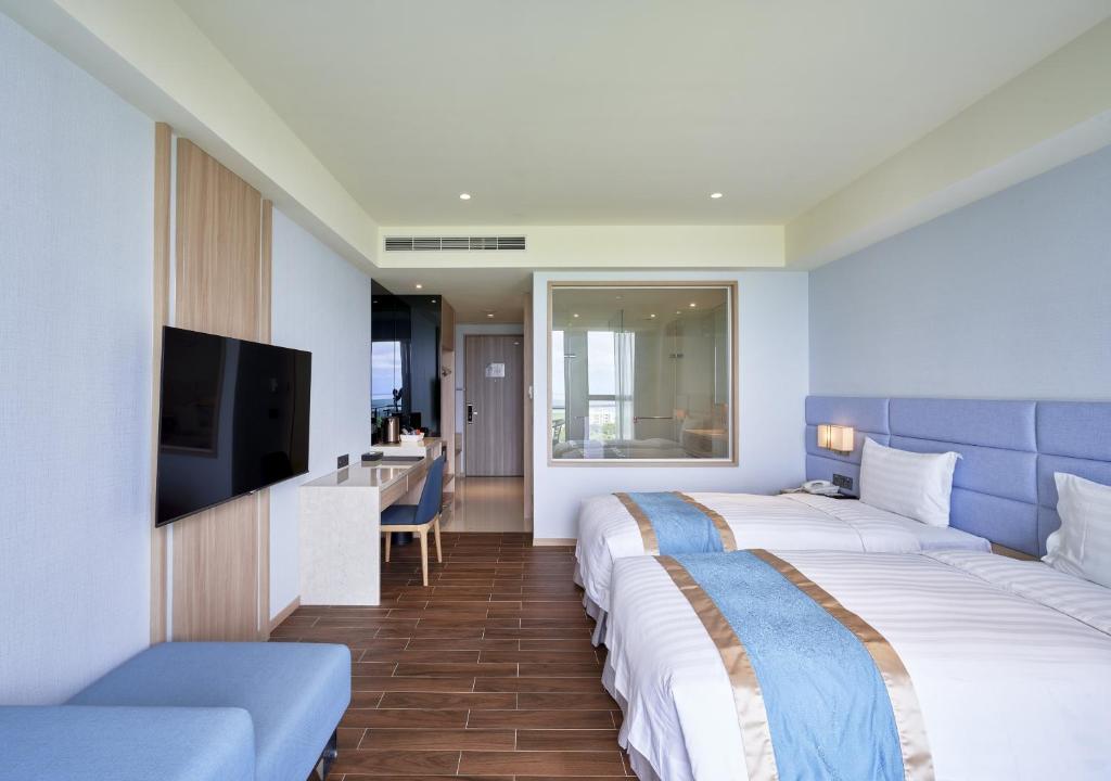 Postel nebo postele na pokoji v ubytování Lanyang Seaview Hotel