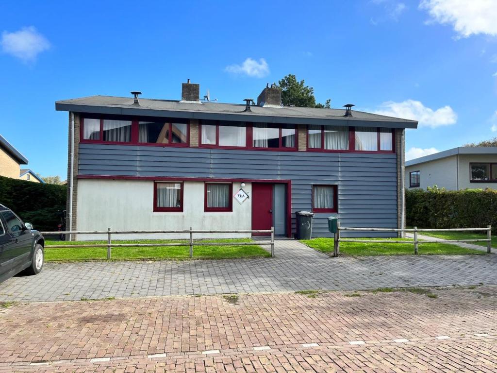 a large house with a red and white at Wijk de Brabander 60 in Cadzand