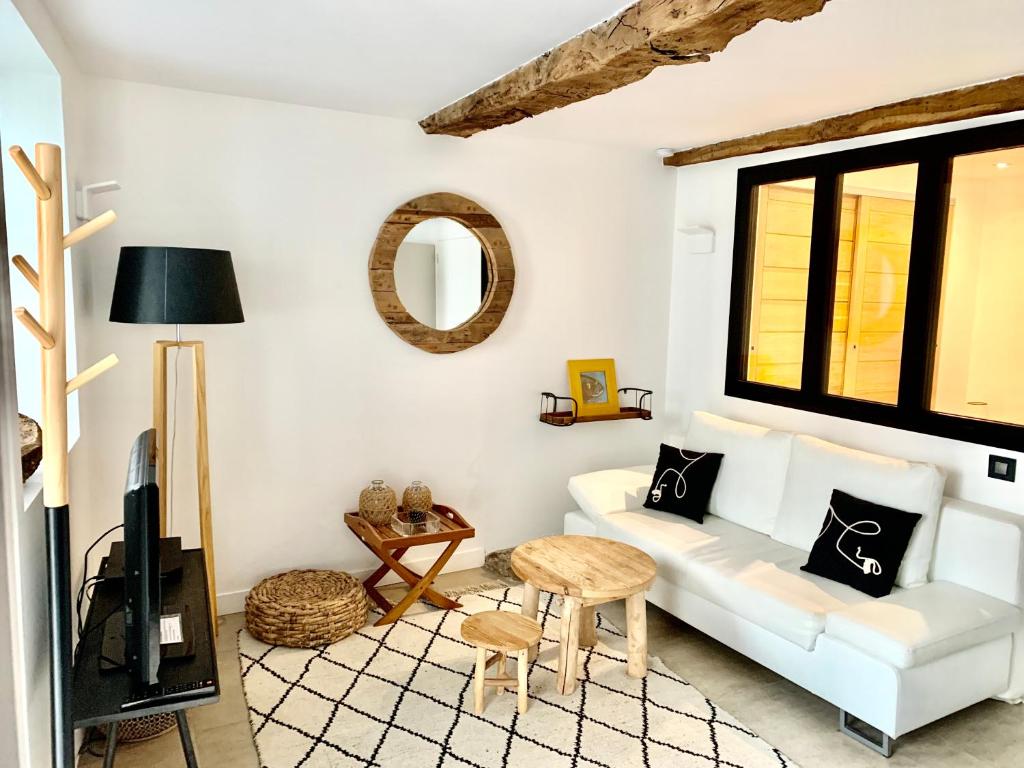 un salon avec un canapé blanc et une télévision dans l'établissement Appartement T2 Comfy - Rdc - Plage 50m - Rue gratuite, à Saint-Malo