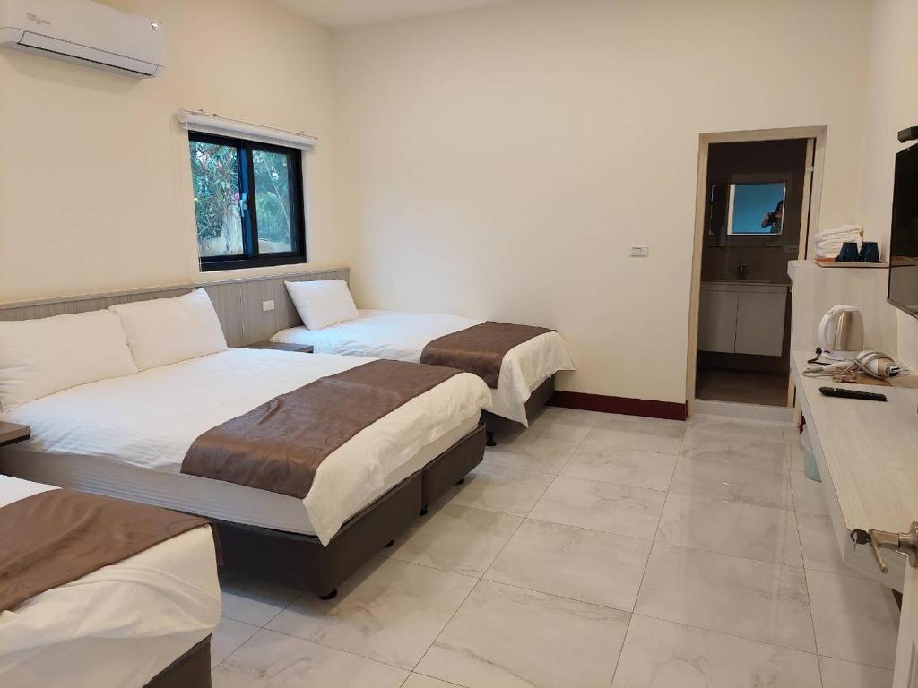 Postel nebo postele na pokoji v ubytování Meinong Yun Shanju Homestay