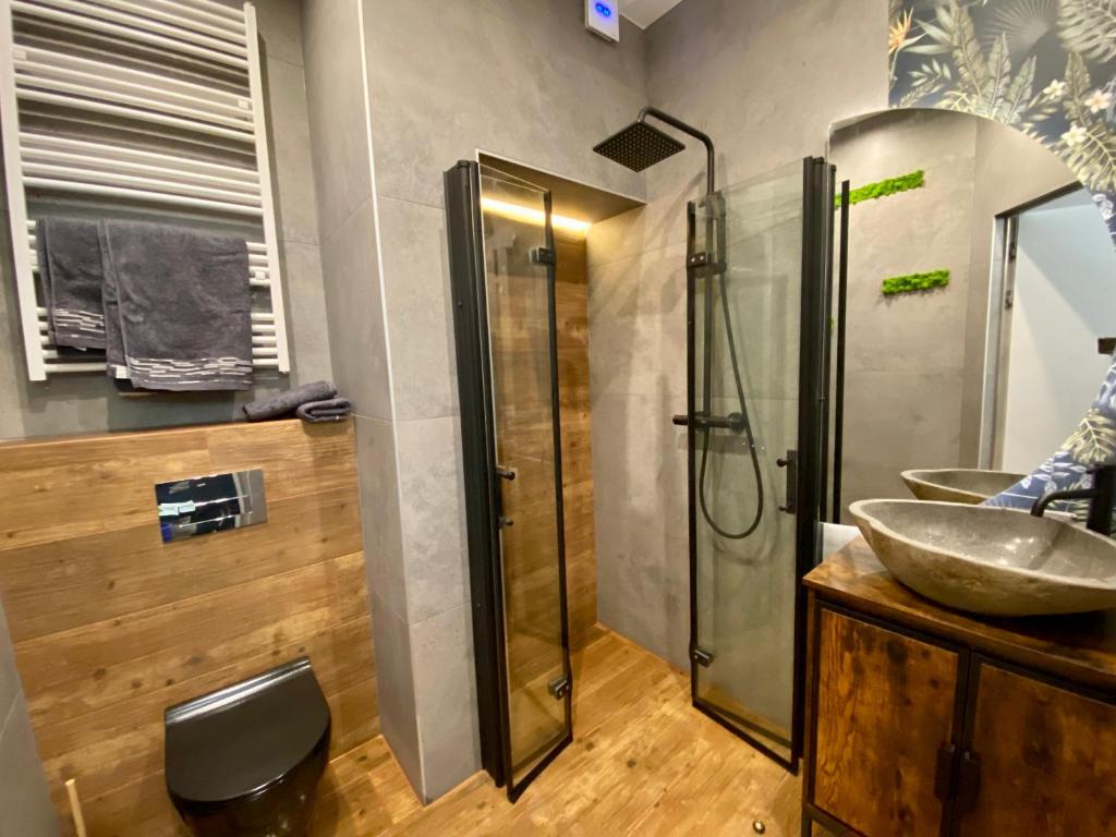 a bathroom with a sink and a shower at Apartament z jacuzzi in Kraków