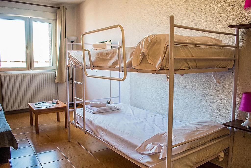 Postel nebo postele na pokoji v ubytování Estudis Turístics Cims Pas 3000