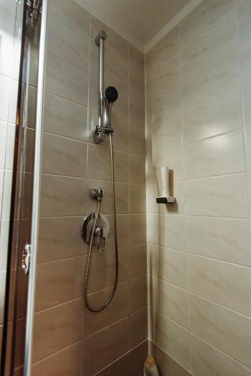 a shower with a shower head in a bathroom at Boutique Damiani in Sibiu