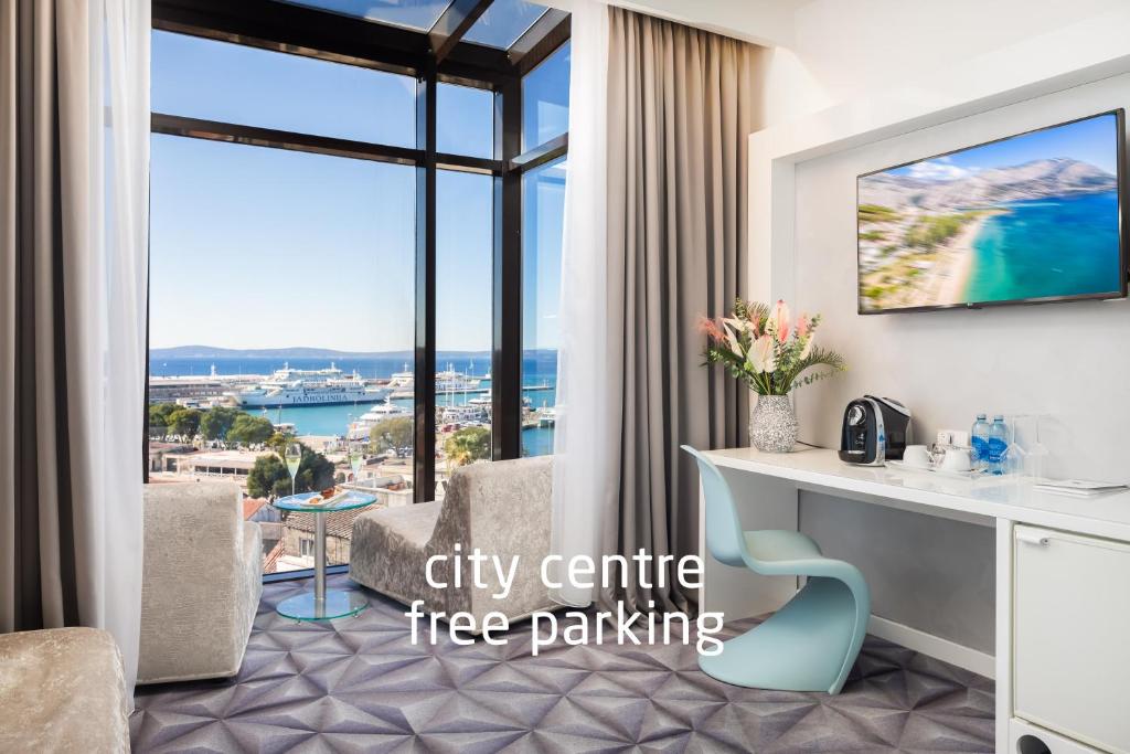 a city centre free parking hotel room with a desk and a large window at Hotel Luxe in Split