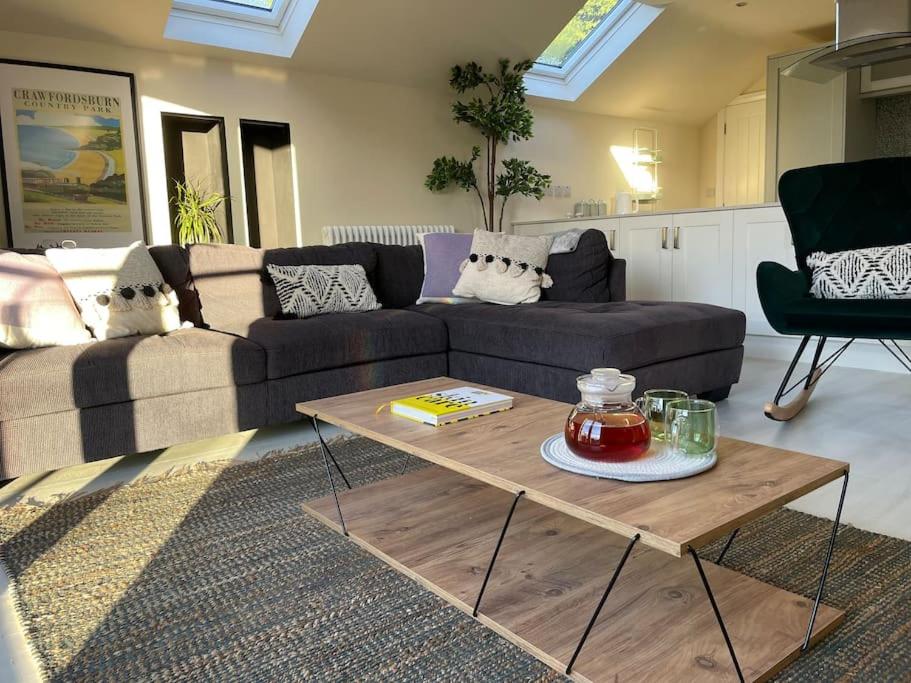 a living room with a couch and a coffee table at Edge Water Cottage-recently constructed in Crawfordsburn