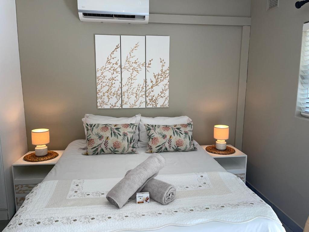 a bedroom with a bed with two lamps on it at Guest house on Gillian Unit 5 in Ballito