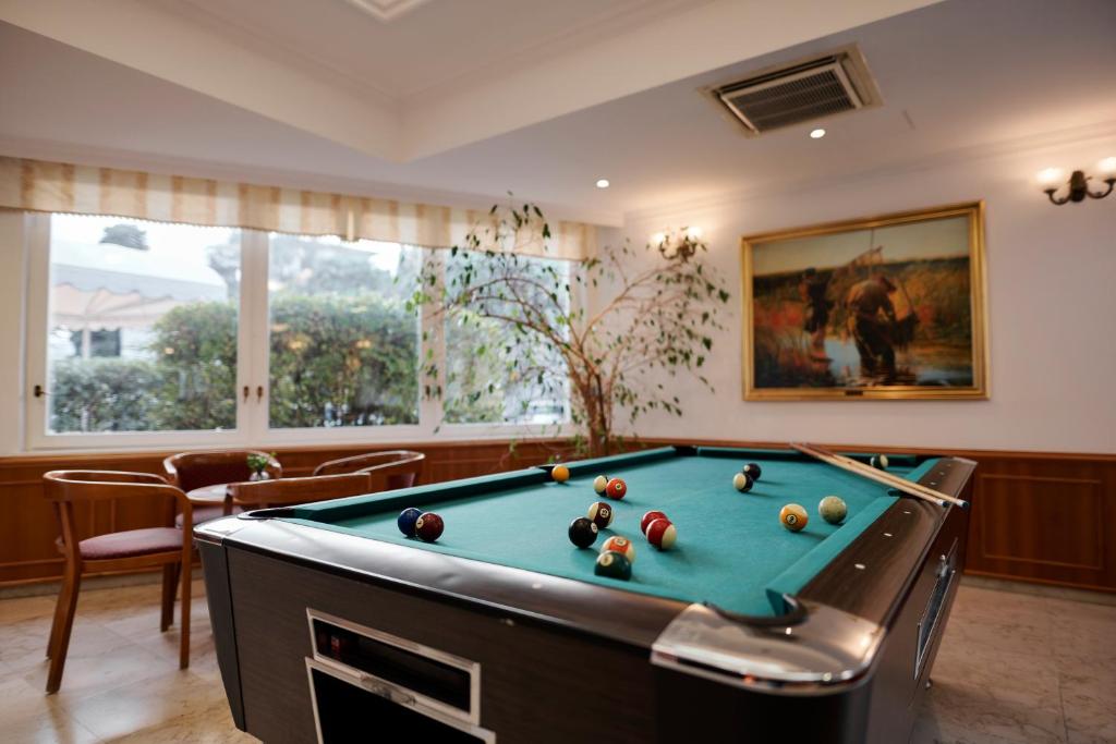a pool table in a living room with a pool table at Hotel Lovran in Lovran
