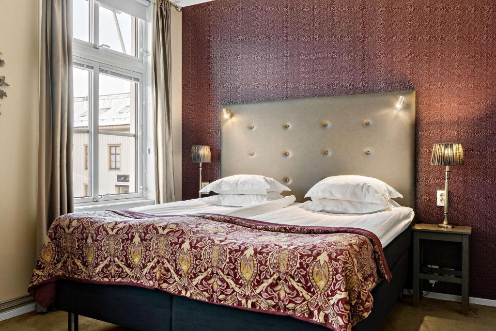 a bedroom with a large bed with a large window at Best Western Plus Edward Hotel in Lidköping