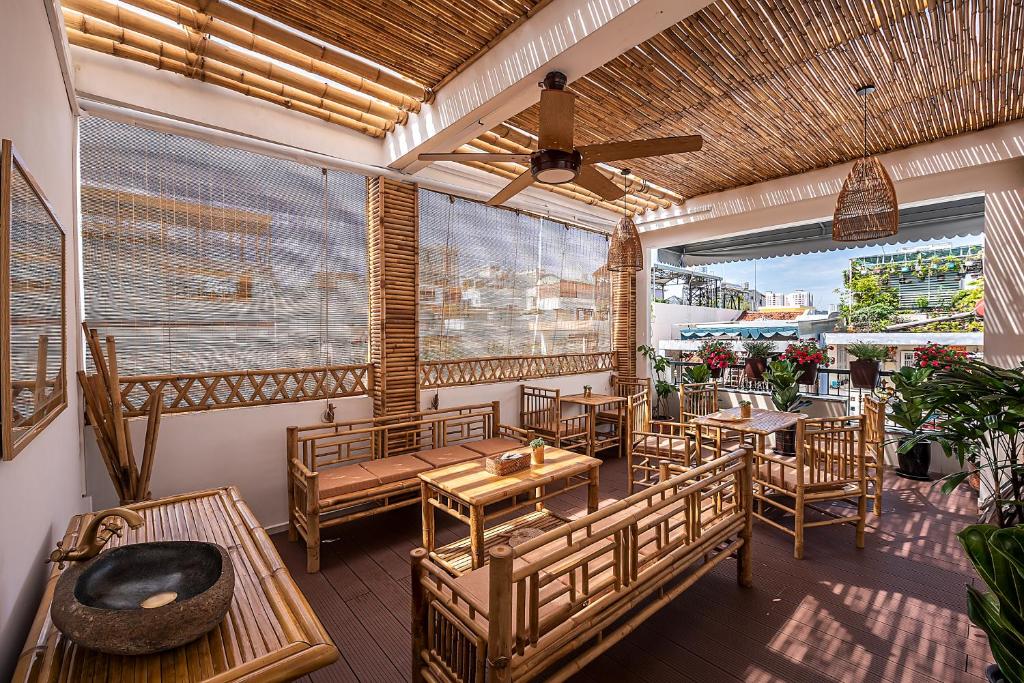 a restaurant with tables and chairs on a patio at Song Anh Indochina Studios Nguyen Thai Binh in Ho Chi Minh City