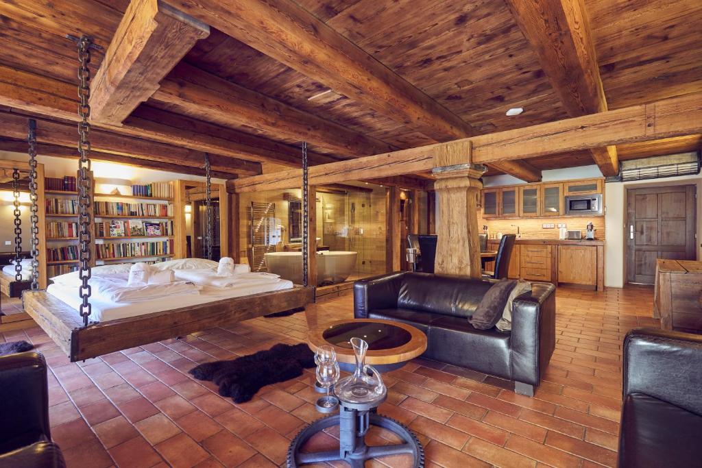 a large living room with a couch and a swing at Mill Apartments in Český Krumlov