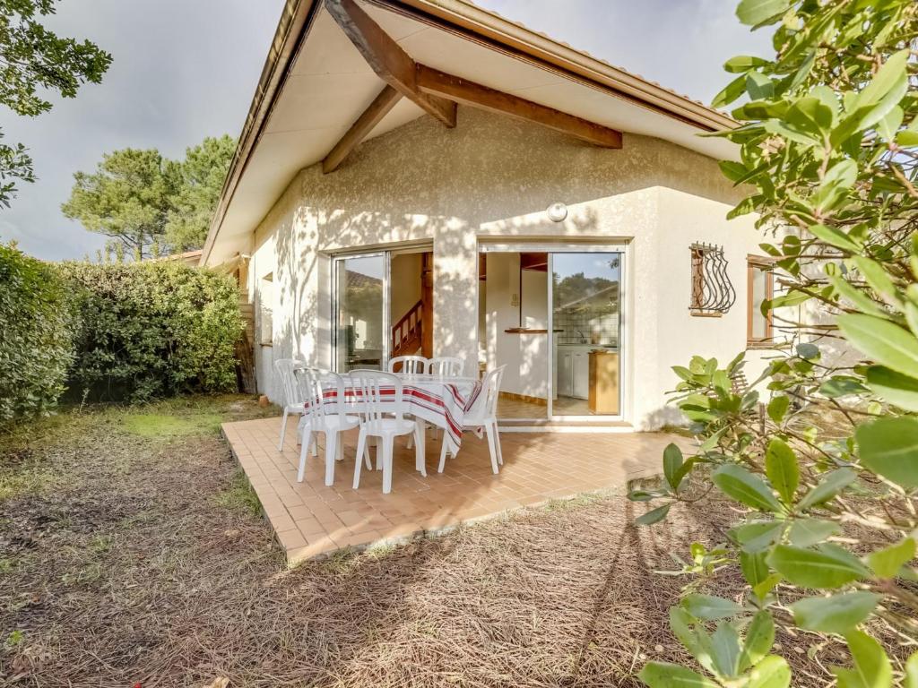 un patio avec une table et des chaises dessus dans l'établissement Maison T2 avec mezzanine, jardin clos, proche plage, quartier calme, Biscarrosse - 4 personnes - FR-1-521-73, à Biscarrosse-Plage