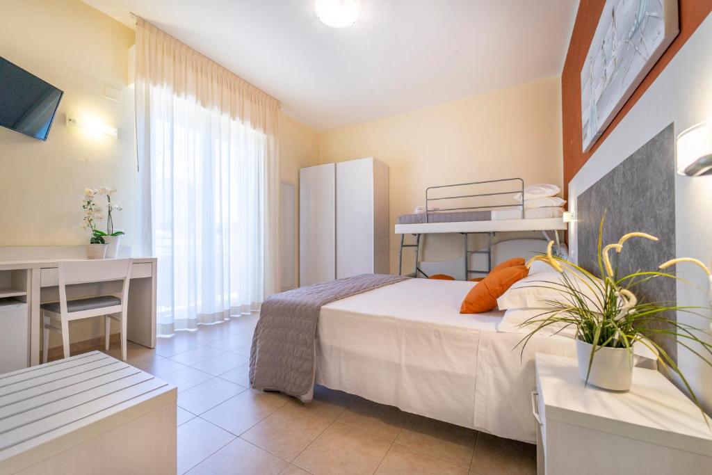A bed or beds in a room at Hotel Romagna