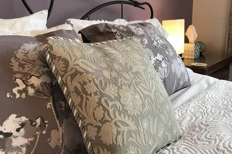 a bed with two pillows on top of it at The Coast Yard B & B and Garden Chalets in Selsey