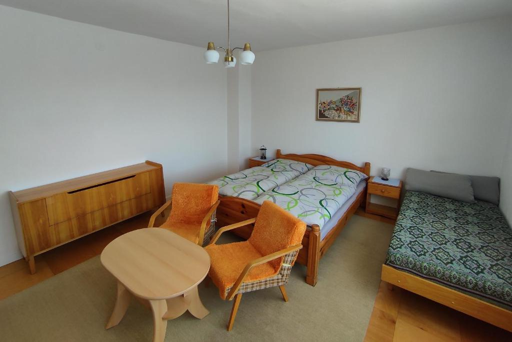 a bedroom with a bed and a table and chairs at Ubytovanie pre Vás in Poprad
