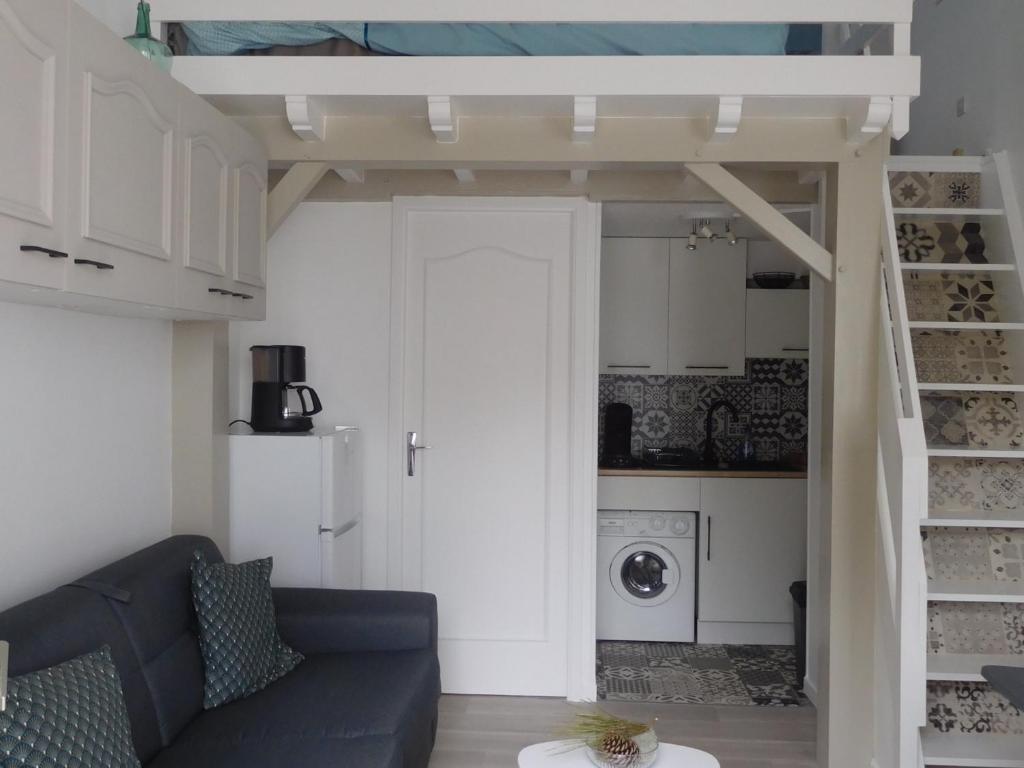 a living room with a couch and a loft bed at Maison La Faute-sur-Mer, 2 pièces, 4 personnes - FR-1-476-184 in La Faute-sur-Mer