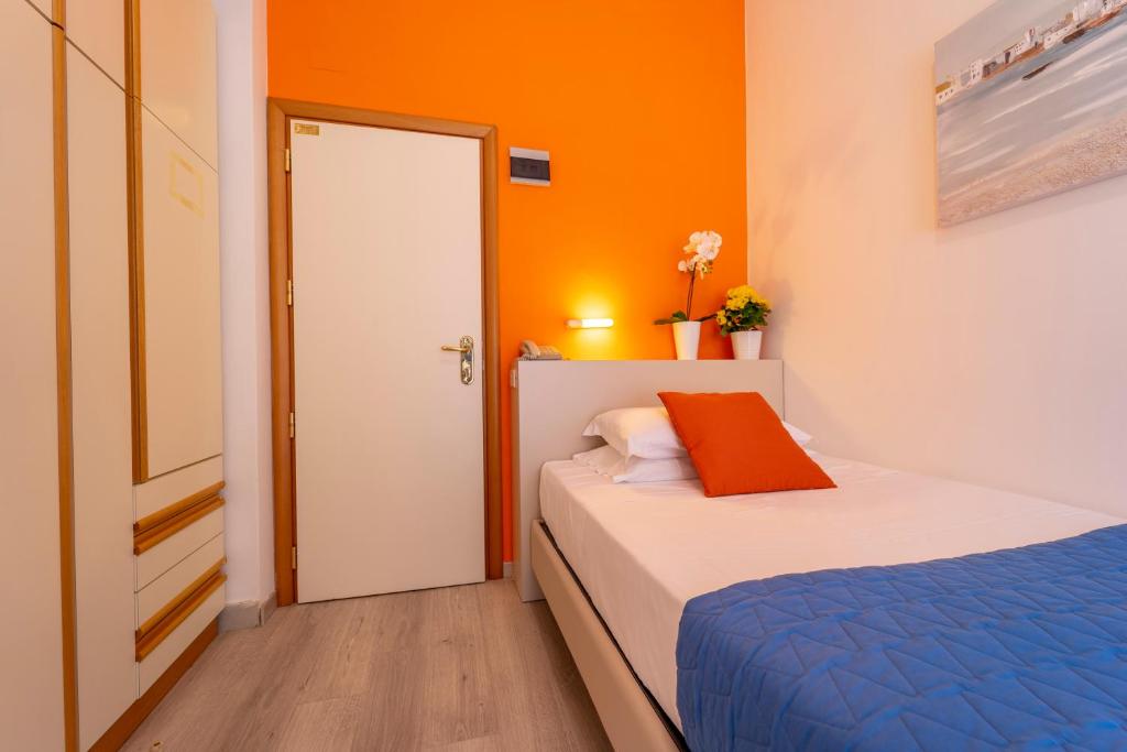A bed or beds in a room at Hotel Romagna