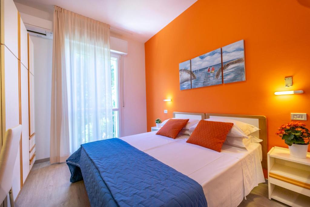 A bed or beds in a room at Hotel Romagna