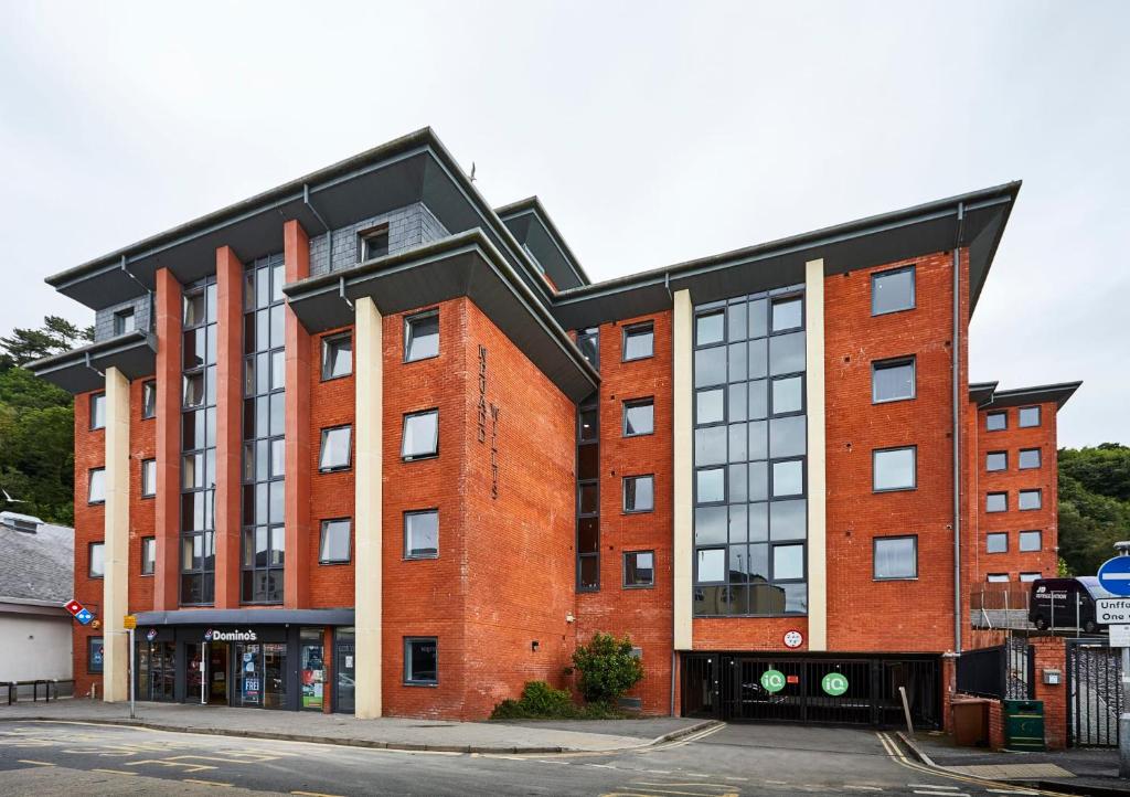a red brick building with a black roof at iQ Ty Willis House in Bangor 3 Min Walk to Bangor Station in Bangor