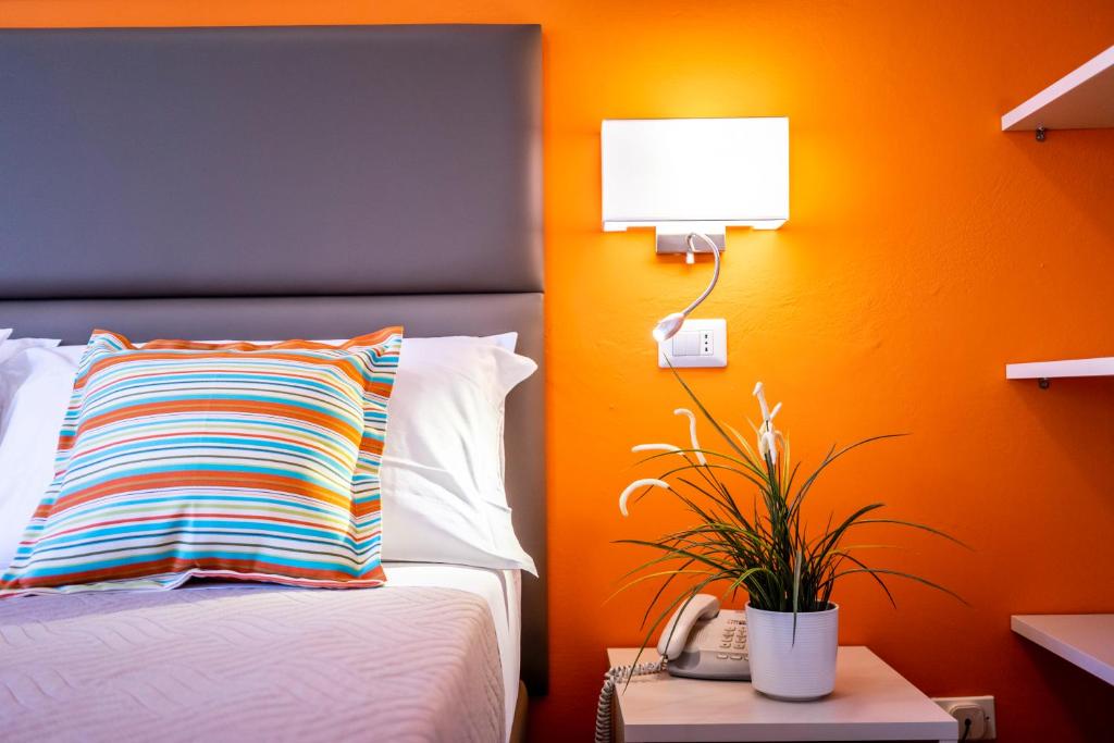 A bed or beds in a room at Hotel Romagna
