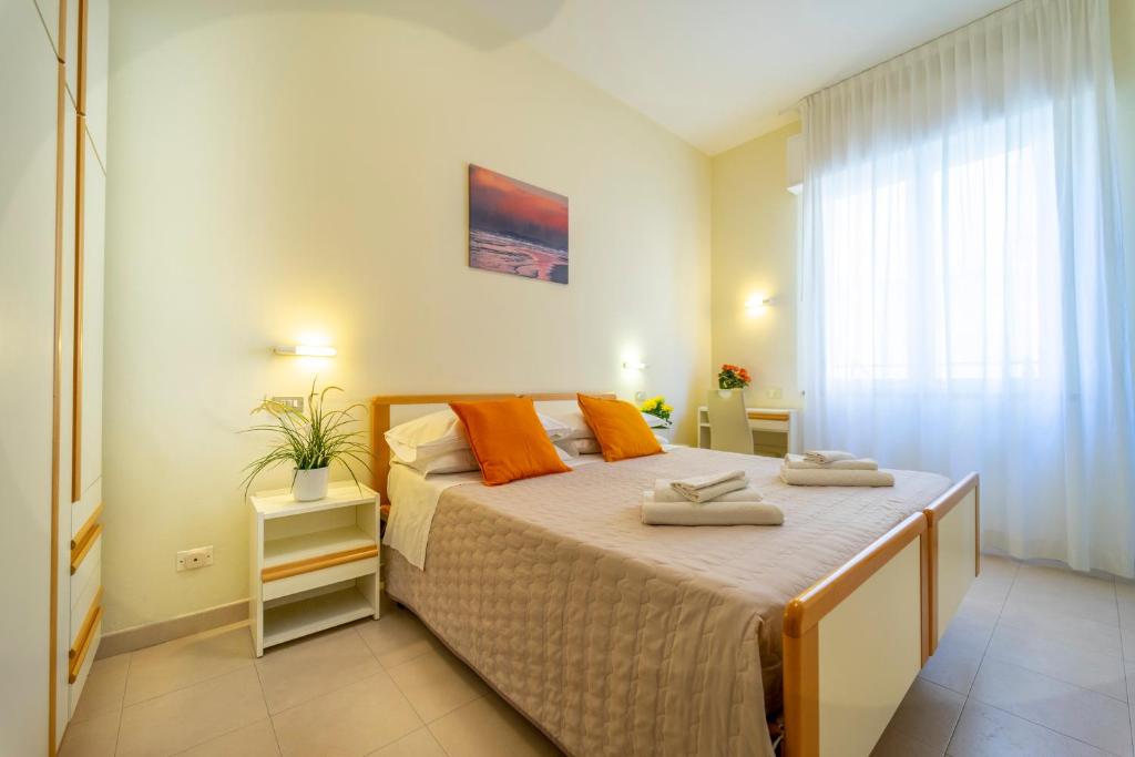 A bed or beds in a room at Hotel Romagna