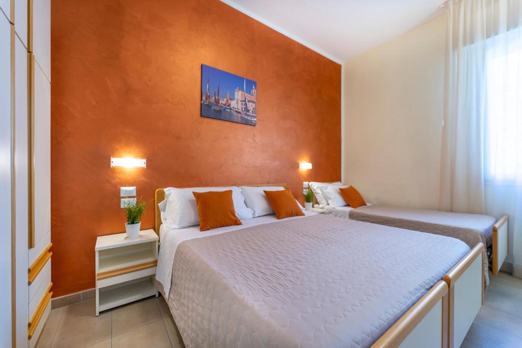 A bed or beds in a room at Hotel Romagna