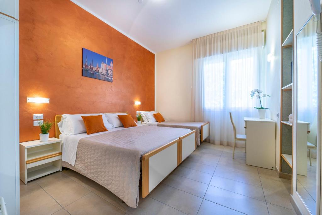 A bed or beds in a room at Hotel Romagna