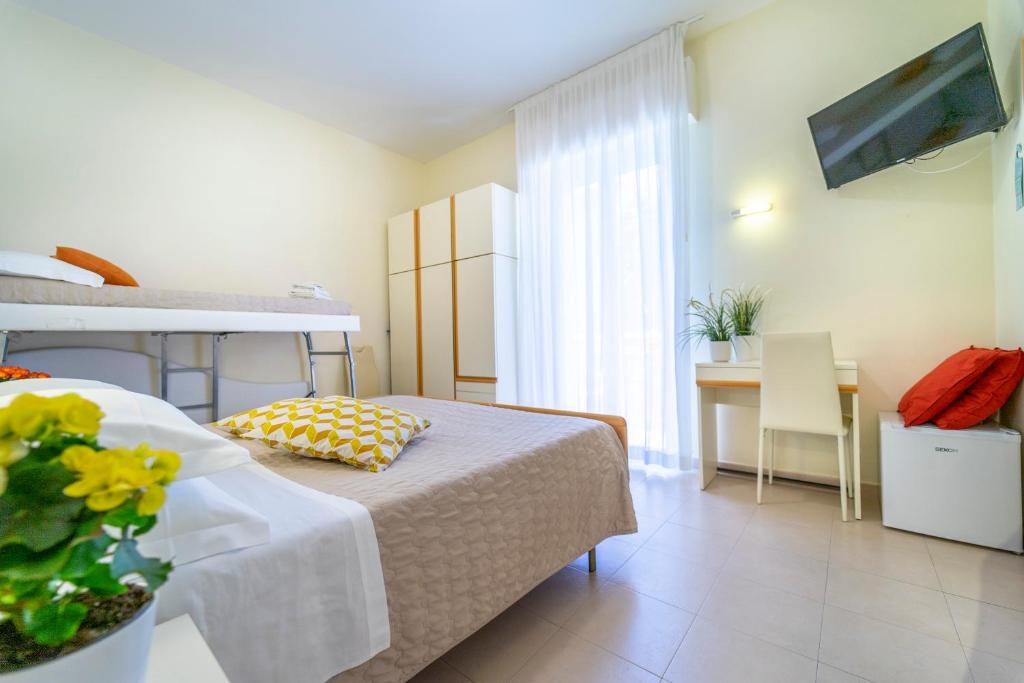 A bed or beds in a room at Hotel Romagna