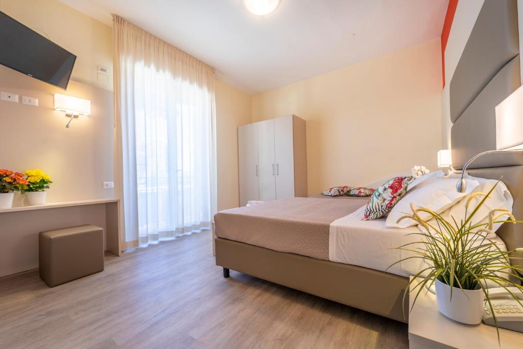 A bed or beds in a room at Hotel Romagna
