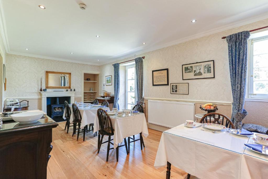 a dining room with tables and chairs in it at Arden House B&B and Self-Catering in Callander