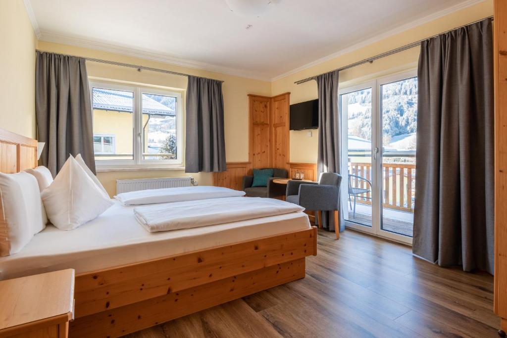 a hotel room with a bed and a balcony at Das Martell in Sankt Johann im Pongau