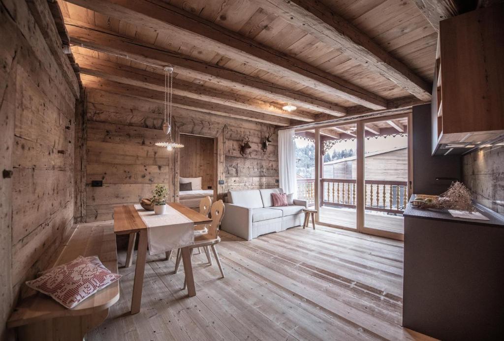 a living room with a couch and a table at Ciasa Somuer - Sorà in San Vigilio Di Marebbe