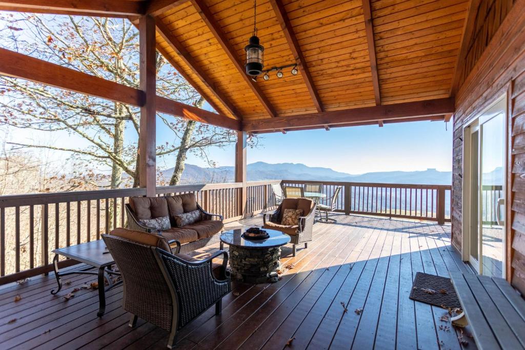 a porch with a couch and chairs on a deck at Grand Panorama in Banner Elk