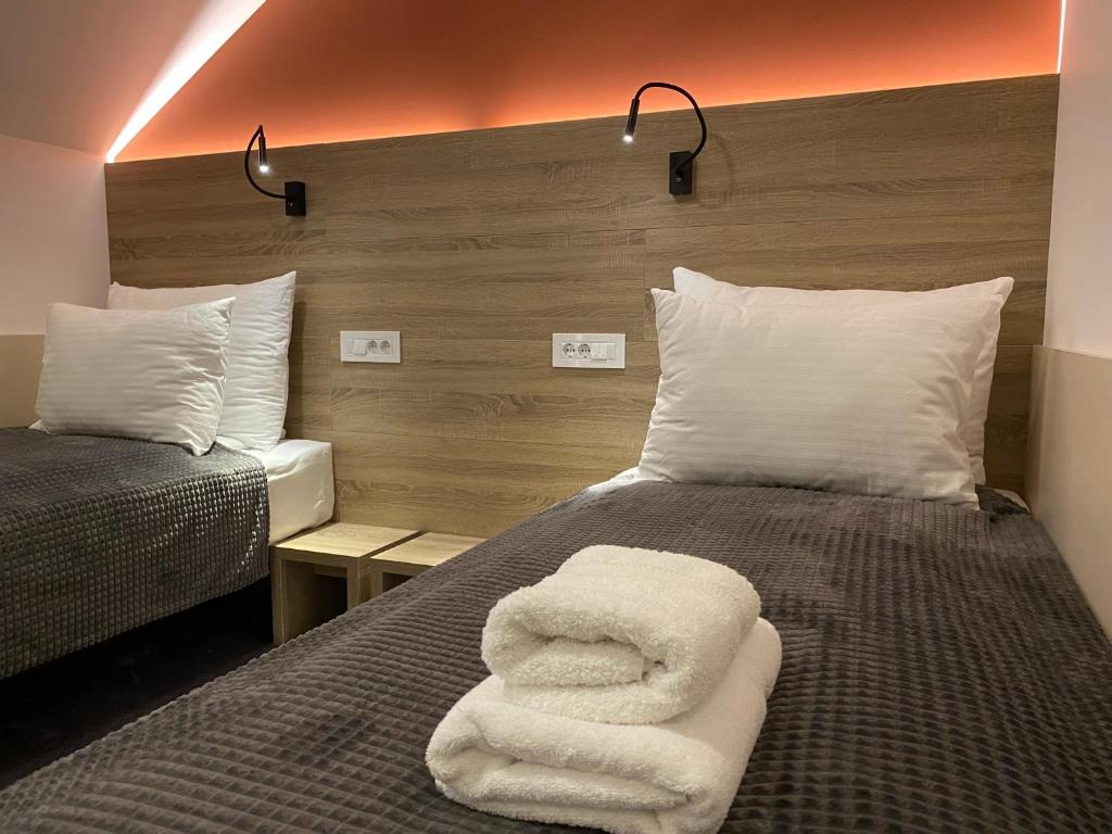 a bedroom with two beds with white towels on it at Konak Stella in Belgrade