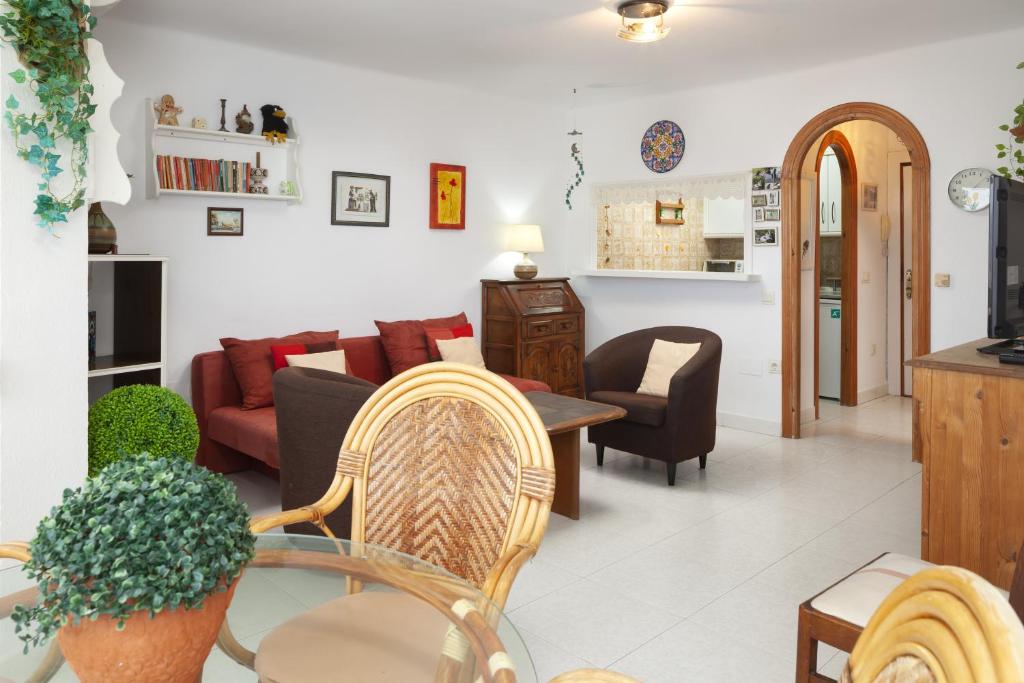 a living room with a couch and a table and chairs at Apartamento junto a la playa A11 in Torrox