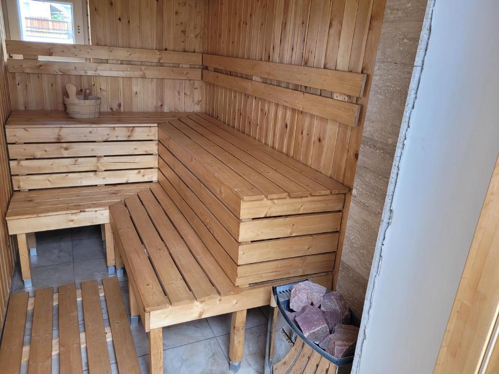 a wooden sauna with a bench in it at Végvári Vendégház in Magyarbóly