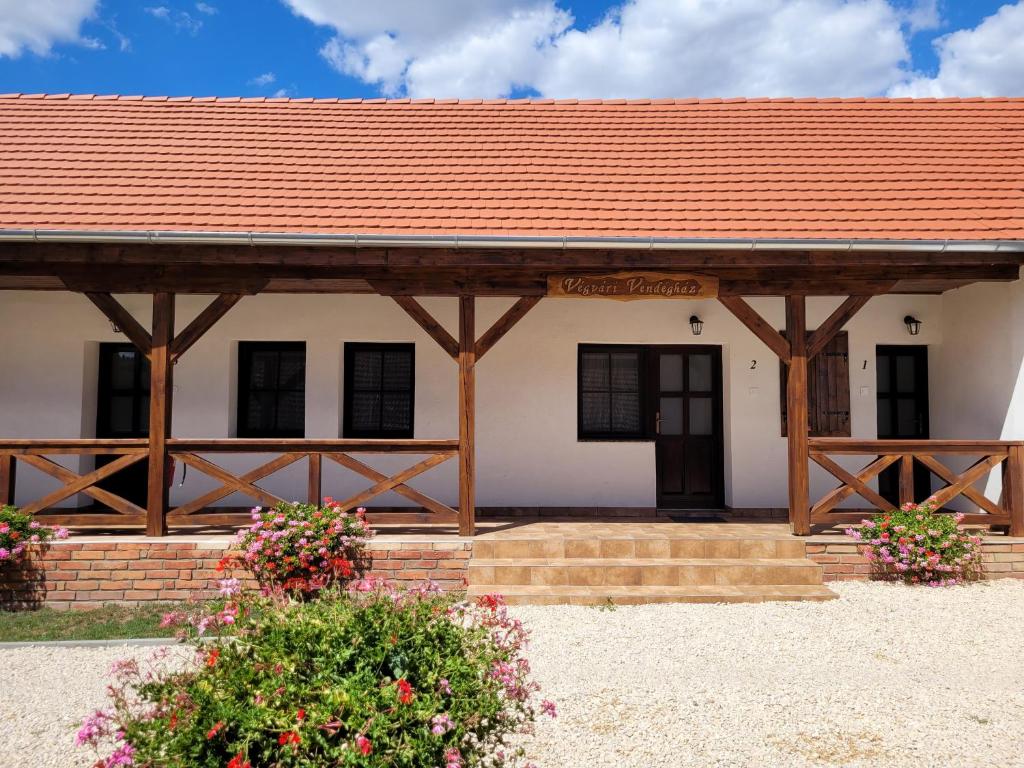 a large white building with a red roof at Végvári Vendégház in Magyarbóly