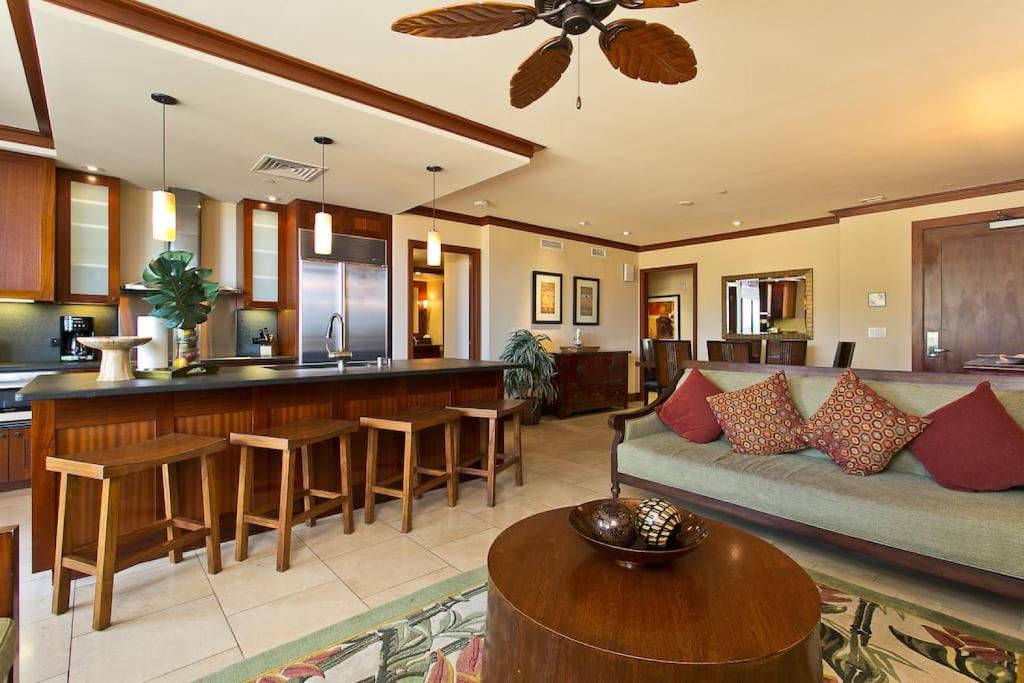 a living room with a couch and a kitchen at Ko Olina Beach Villas O410 - 2BR Luxury Condo with Partial Ocean View in Kapolei