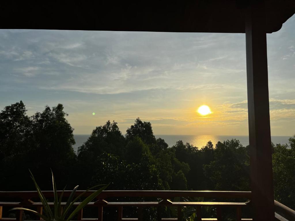 a view of the sunset from the porch of a house at Mountain House Phú Quốc in Phu Quoc